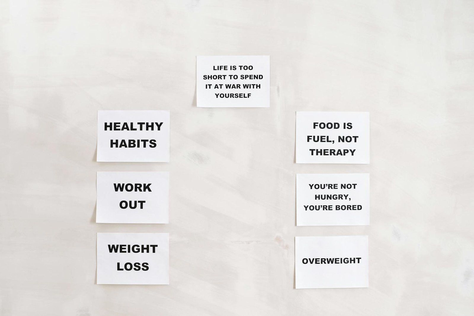 Minimalist display of motivational health and wellness quotes emphasizing healthy habits and weight management.